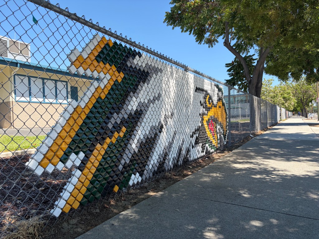 Chain link fence with an eagle logo embedded